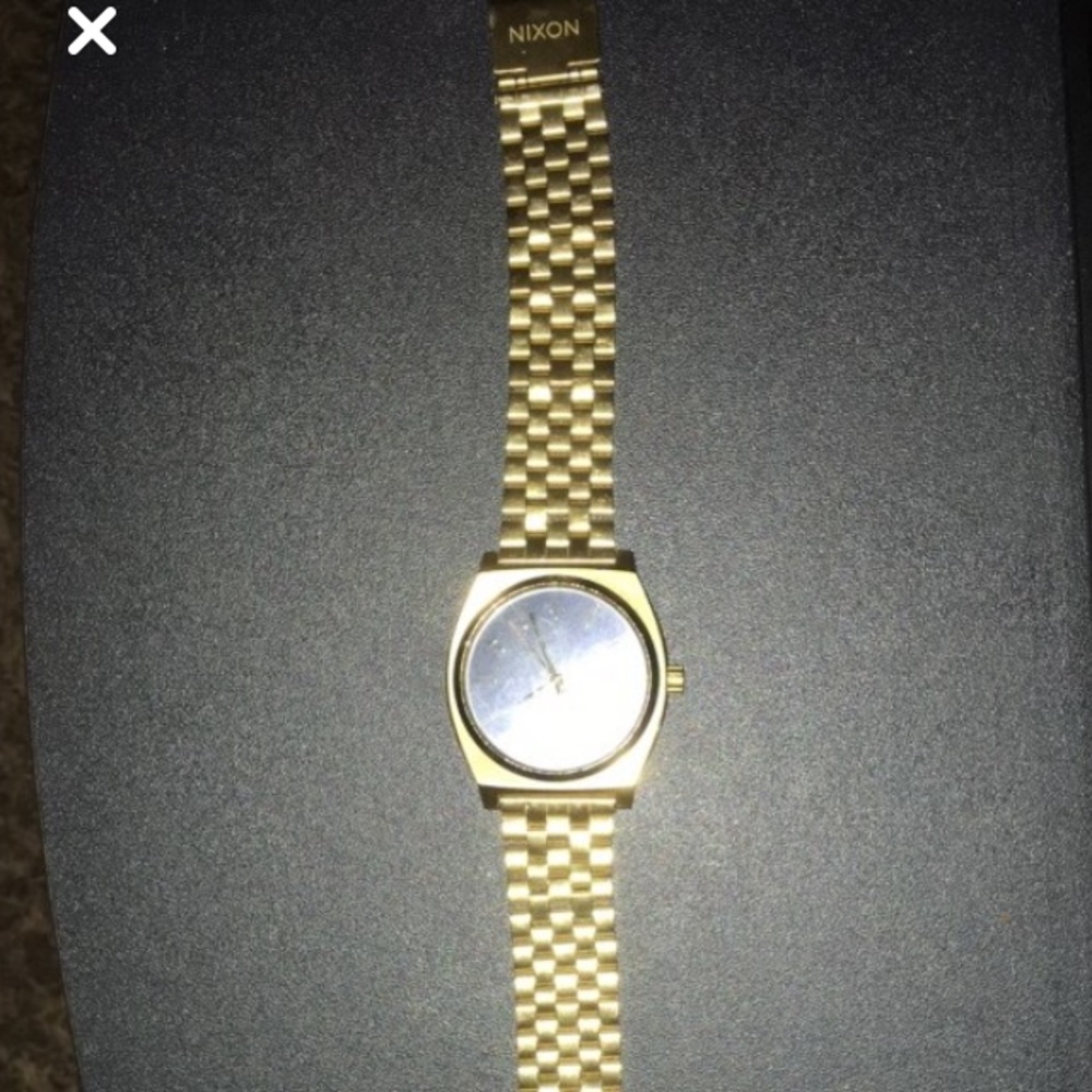 Round gold analog nixon watch
